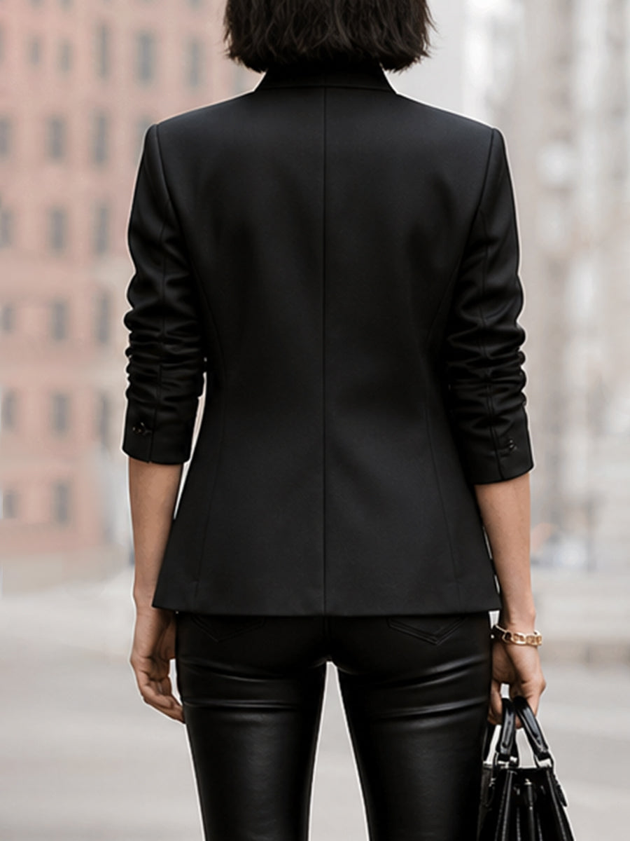 Black asymmetric jacket with a stand collar and a round clasp at the neck