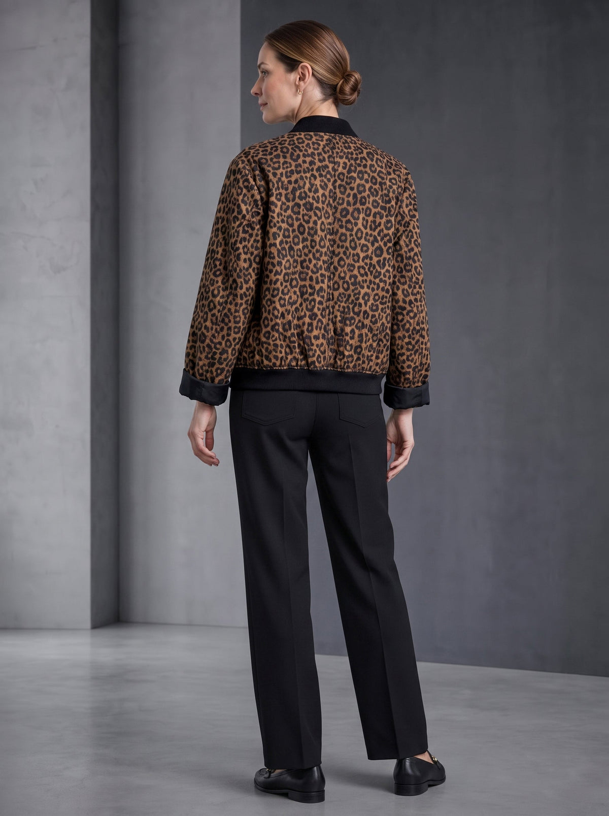 Leopard print bomber jacket with black ribbed collar, cuffs and hem