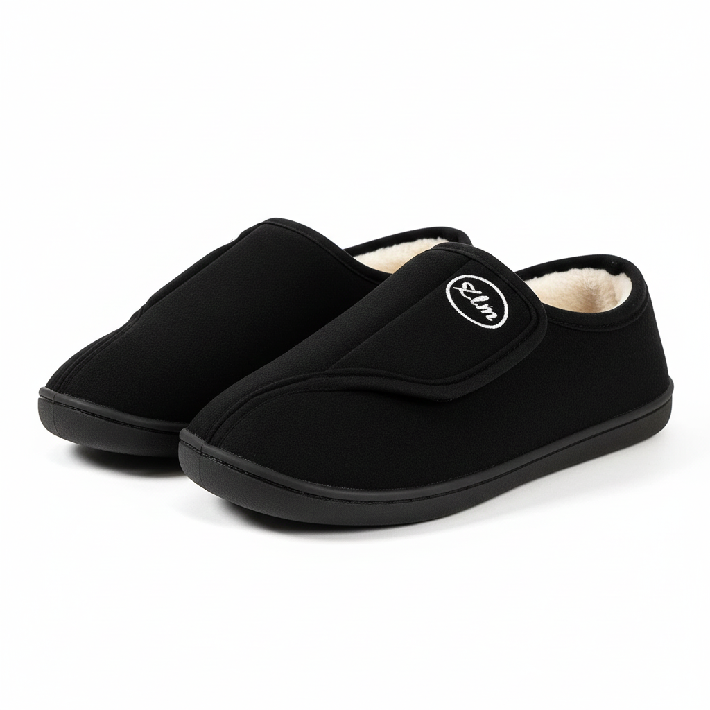 Unisex wide-fit slippers in a suede look with a touch-close strap and fleece lining in black