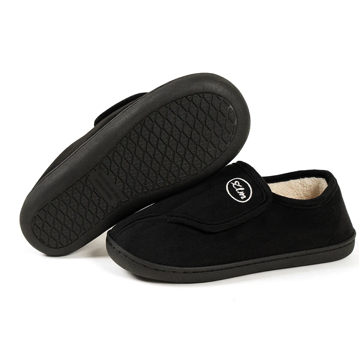 Unisex wide-fit slippers in a suede look with a touch-close strap and fleece lining