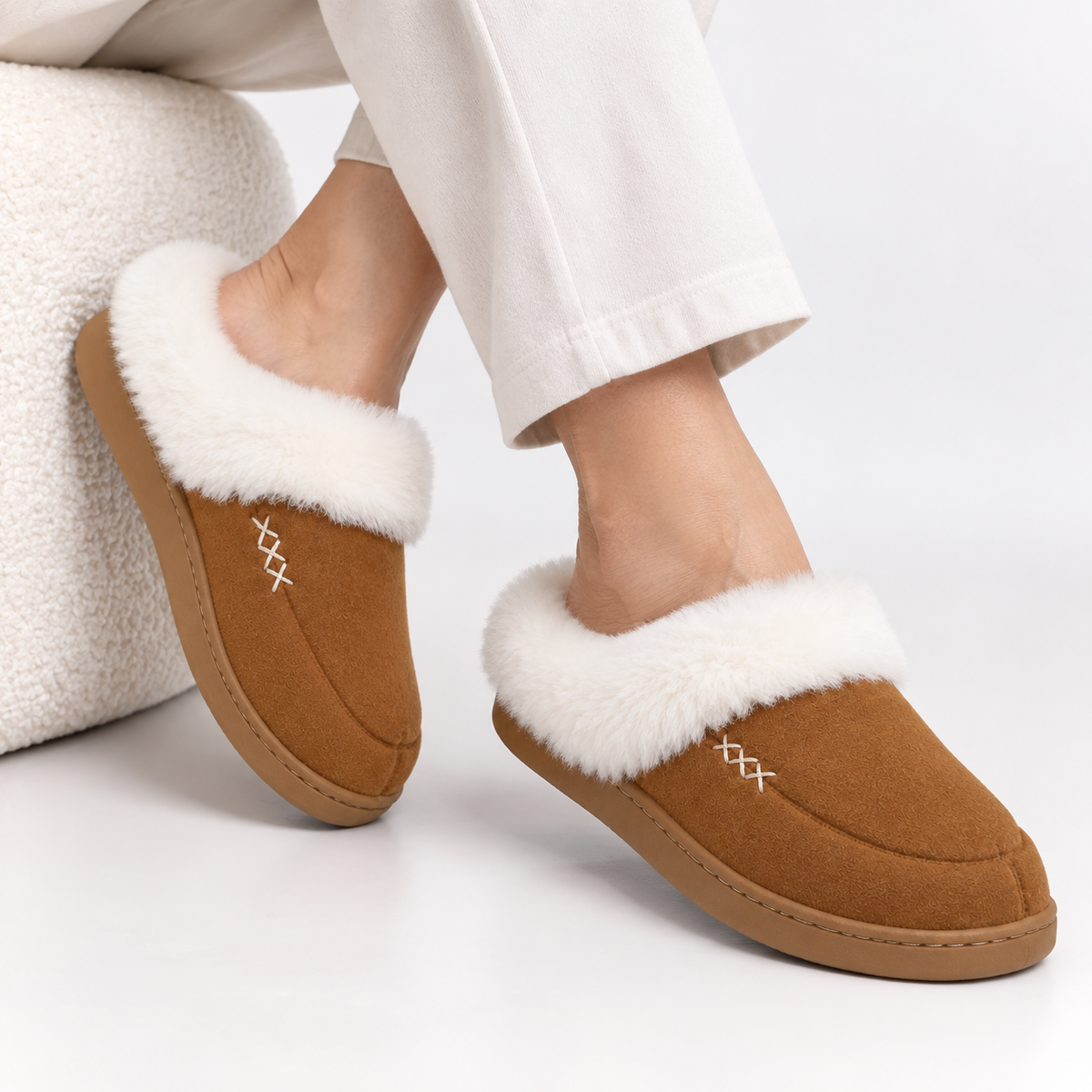Women's slippers with a deep faux fur cuff and a cross-stitch detail