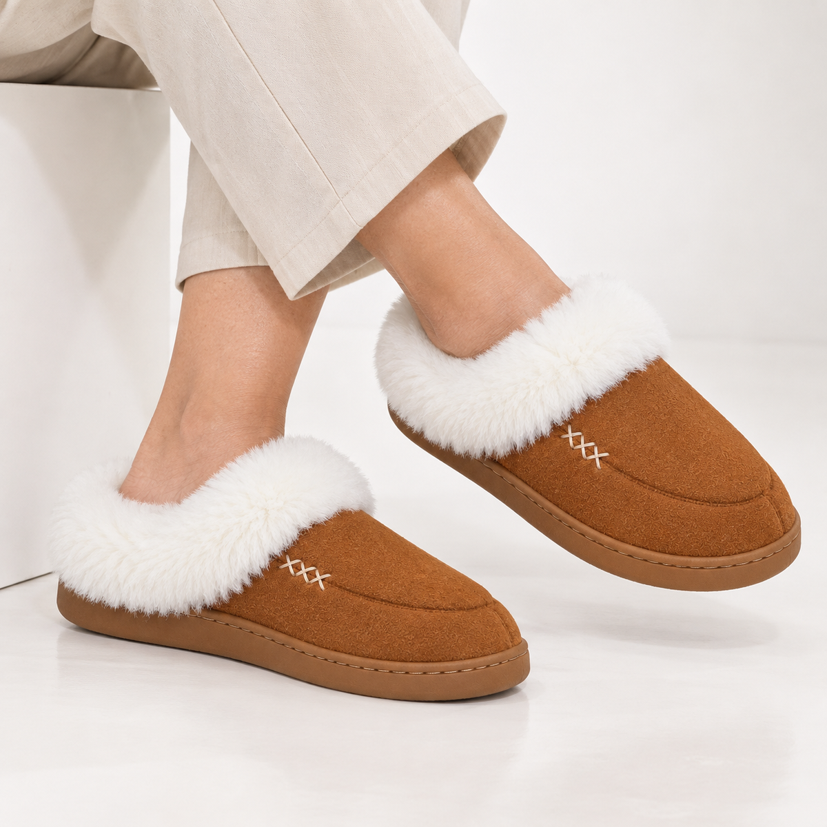 Women's slippers with a deep faux fur cuff and a cross-stitch detail