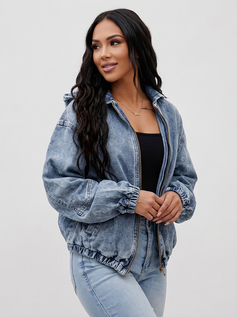 Light wash hooded denim jacket with a zip front and gathered cuffs