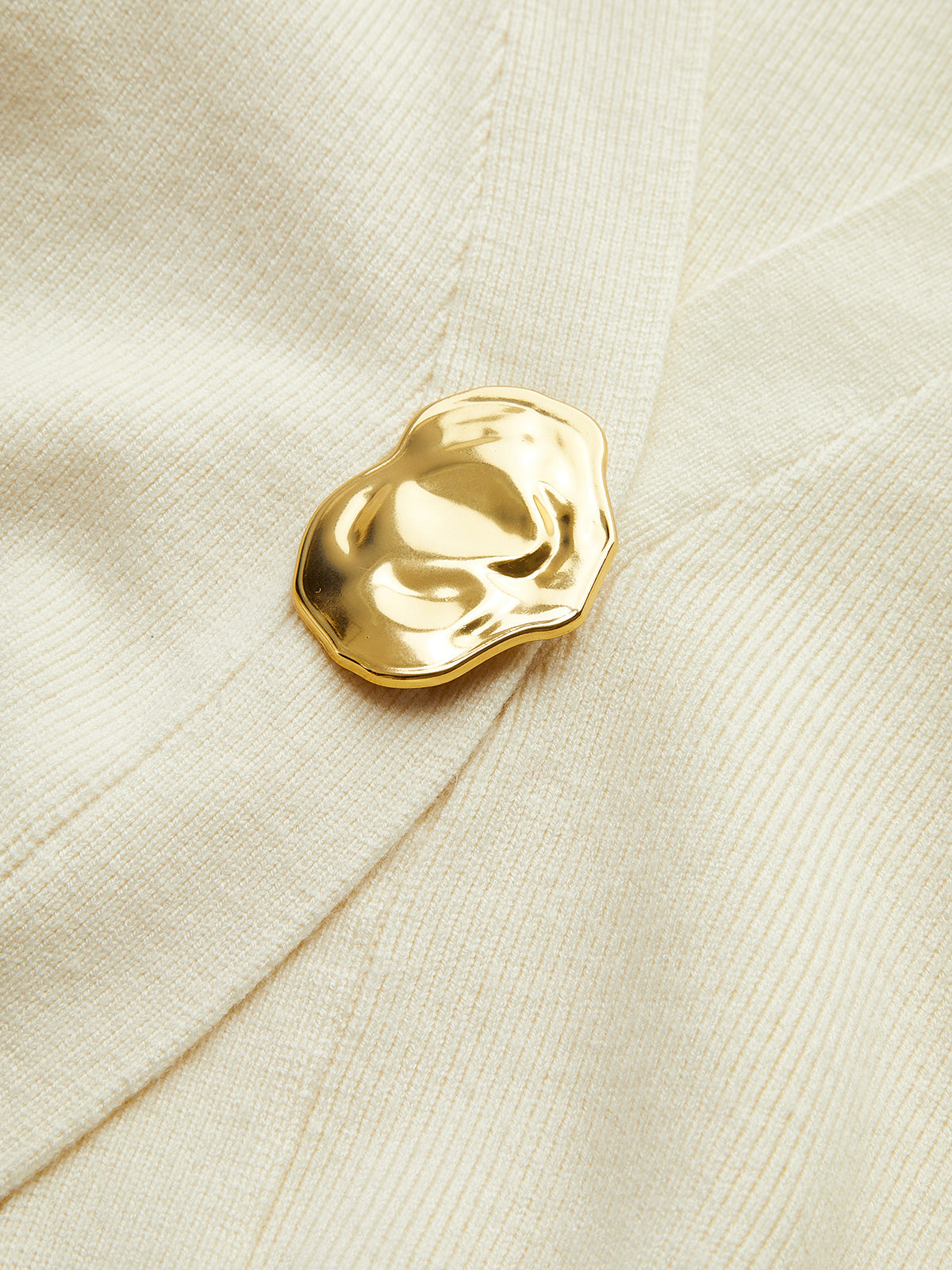 Women's deep V-neck cardigan with a single gold-tone button at the waist