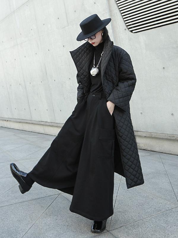 Long black quilted wrap coat with a fold-over collar and ring-buckle belt