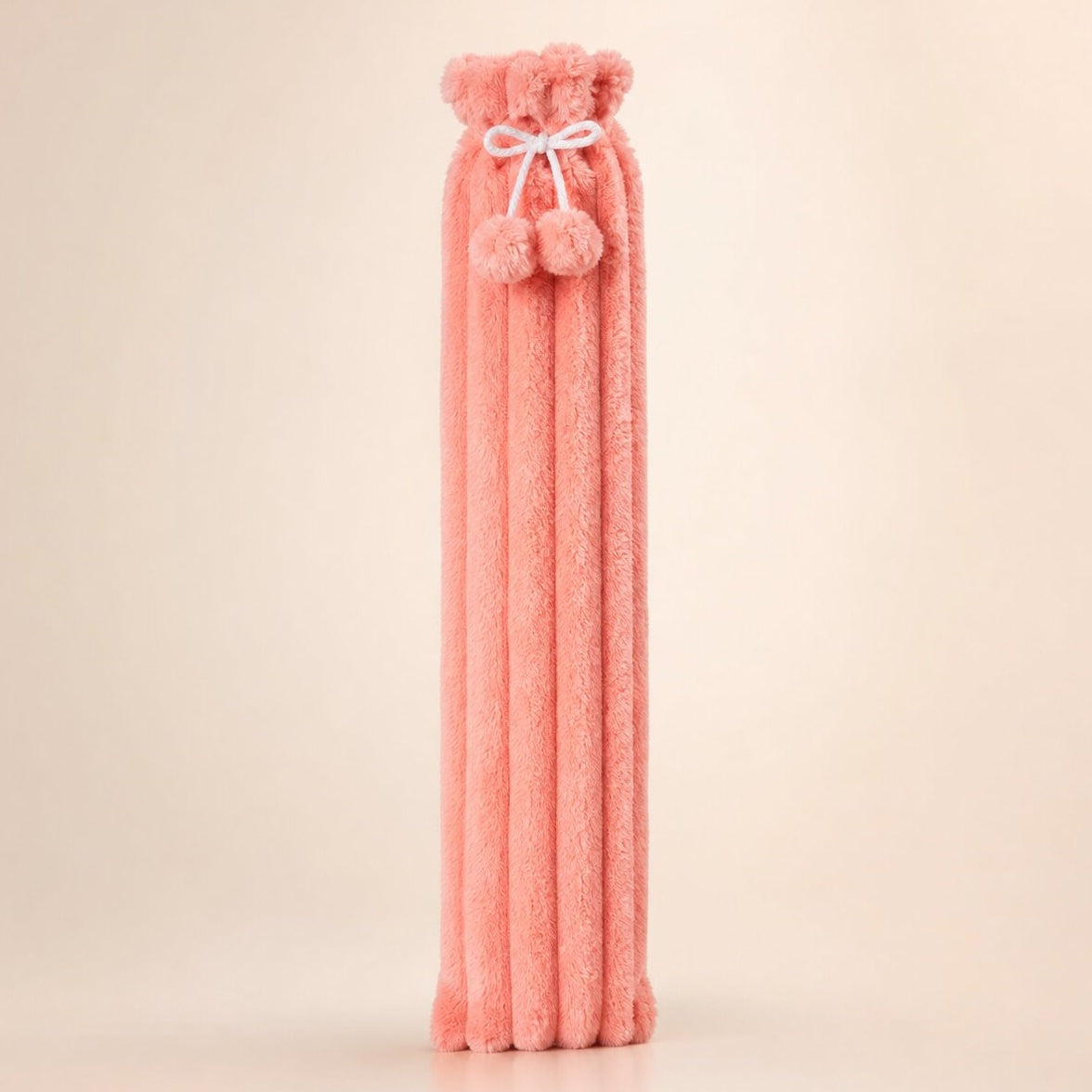 Extra long 83 cm hot water bottle with a plush cover and pompoms - coral pink ribbed