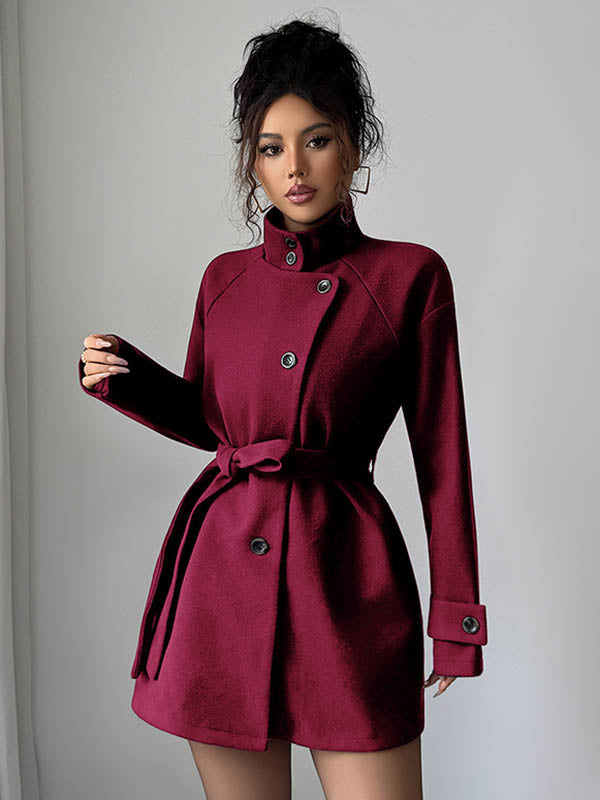Short belted coat with a stand collar and an asymmetric button front