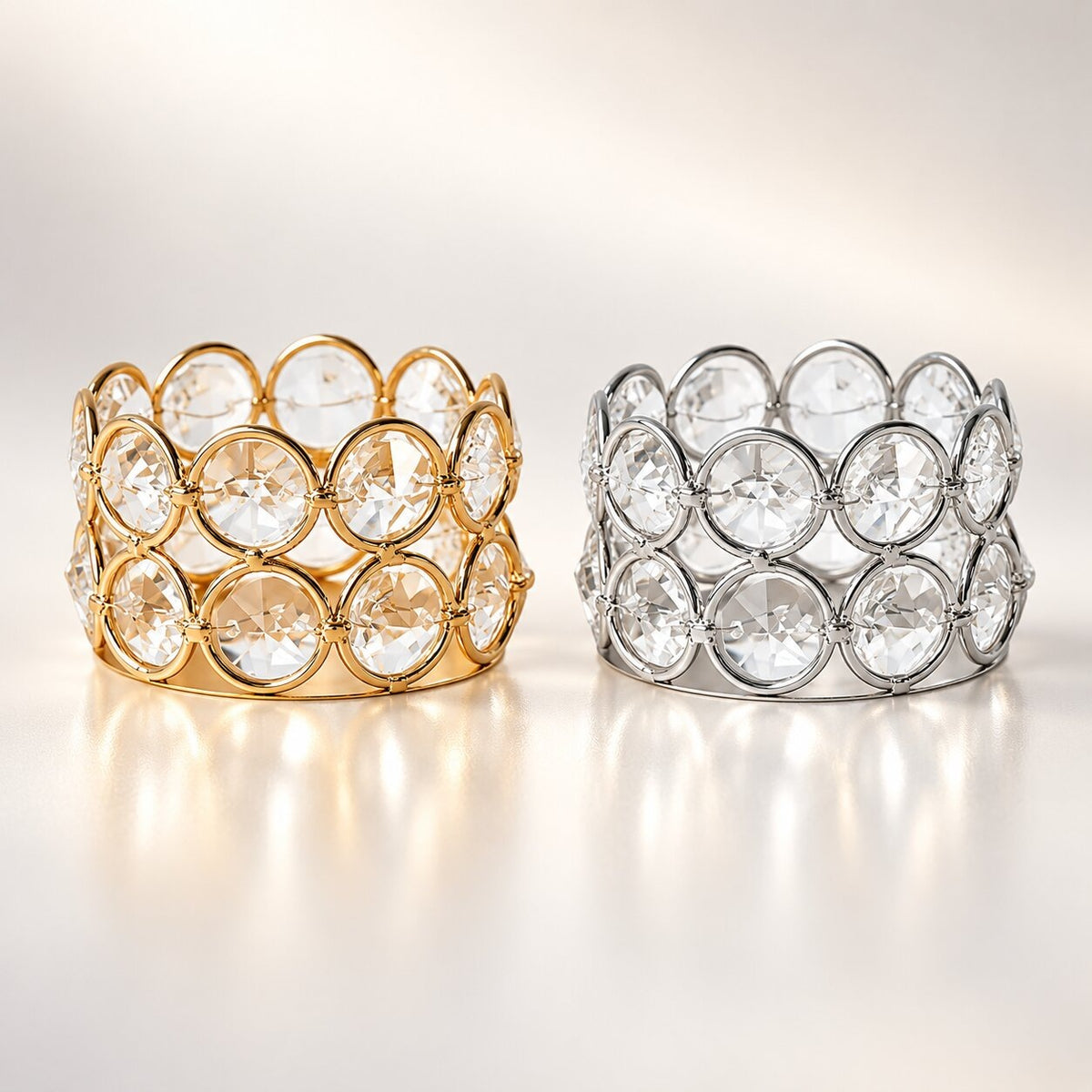 Two metal tea light holders lined with round, faceted glass stones