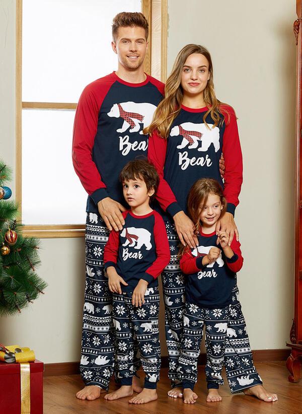 Matching family Christmas pyjamas with a polar bear print and snowflake bottoms
