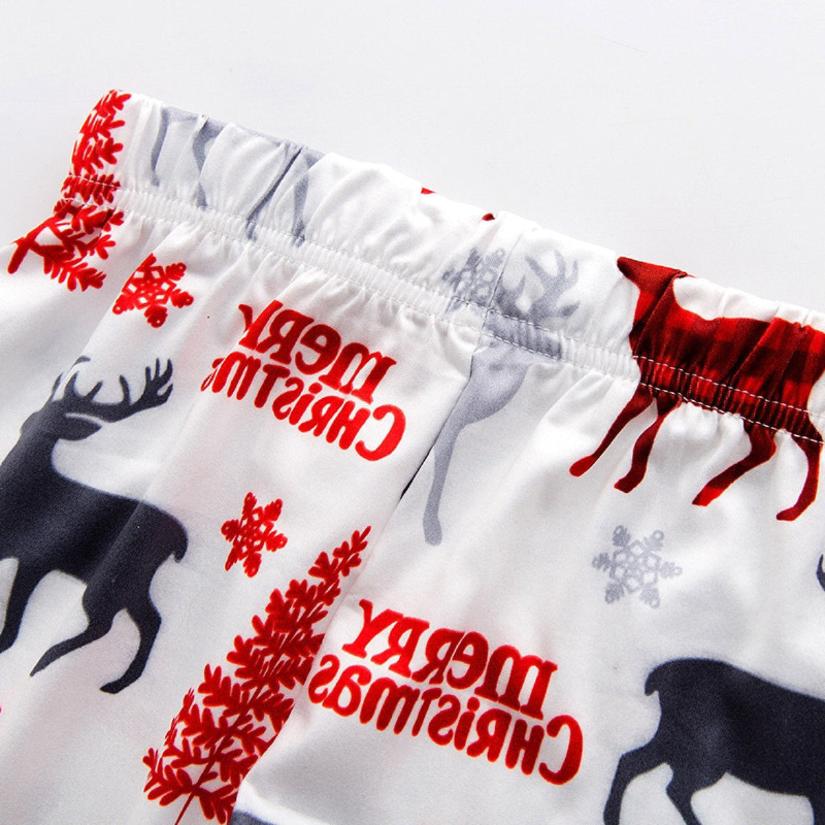 Matching family Christmas pyjamas with a Santa top and white reindeer bottoms