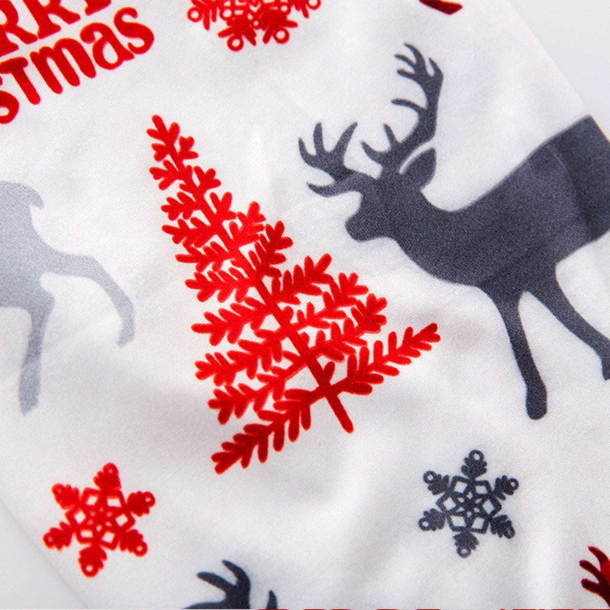 Matching family Christmas pyjamas with a Santa top and white reindeer bottoms