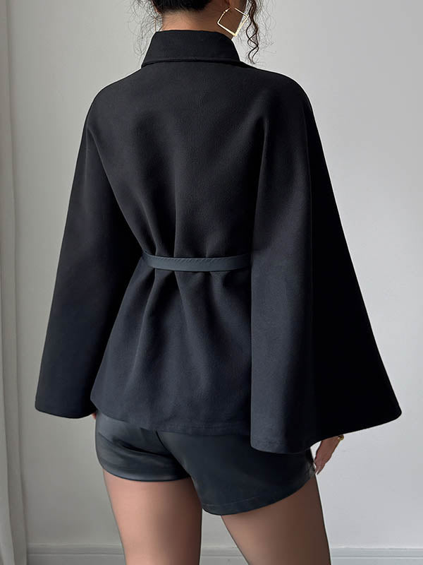 Black cape coat with a shirt collar and a buckled belt at the waist