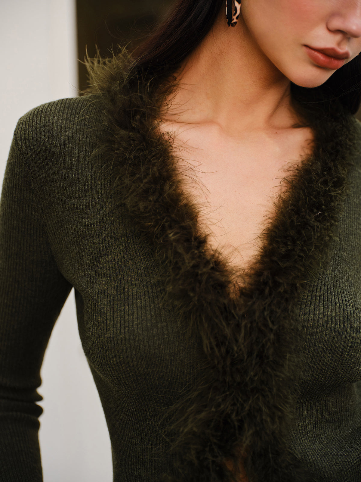 Women's fitted rib knit cardigan with a V-neck and fluffy trim