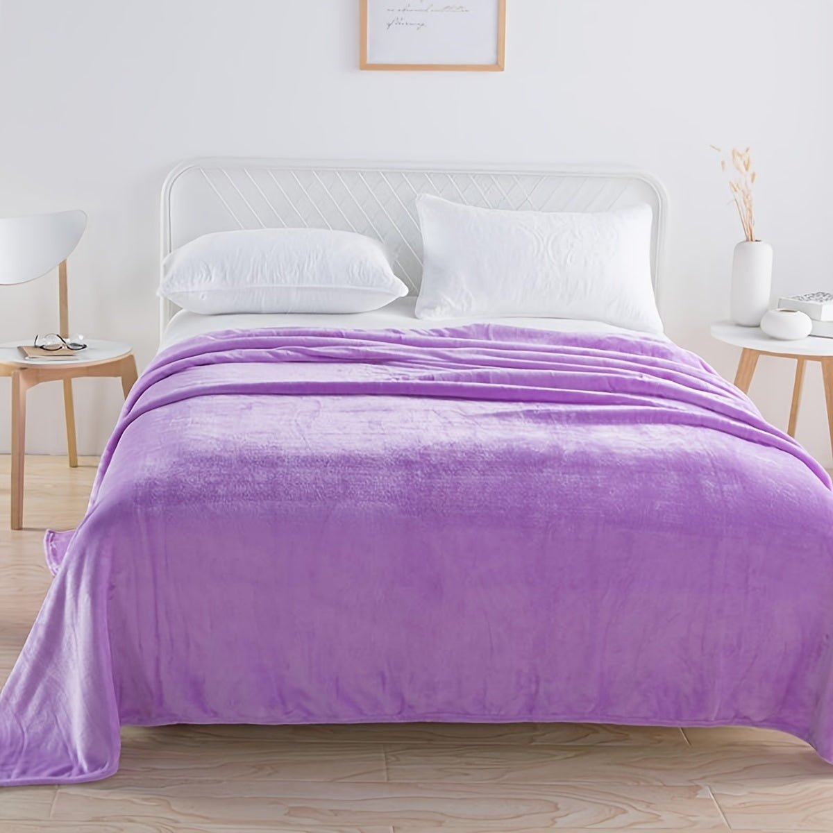 Plain flannel fleece blanket over a bed - lilac