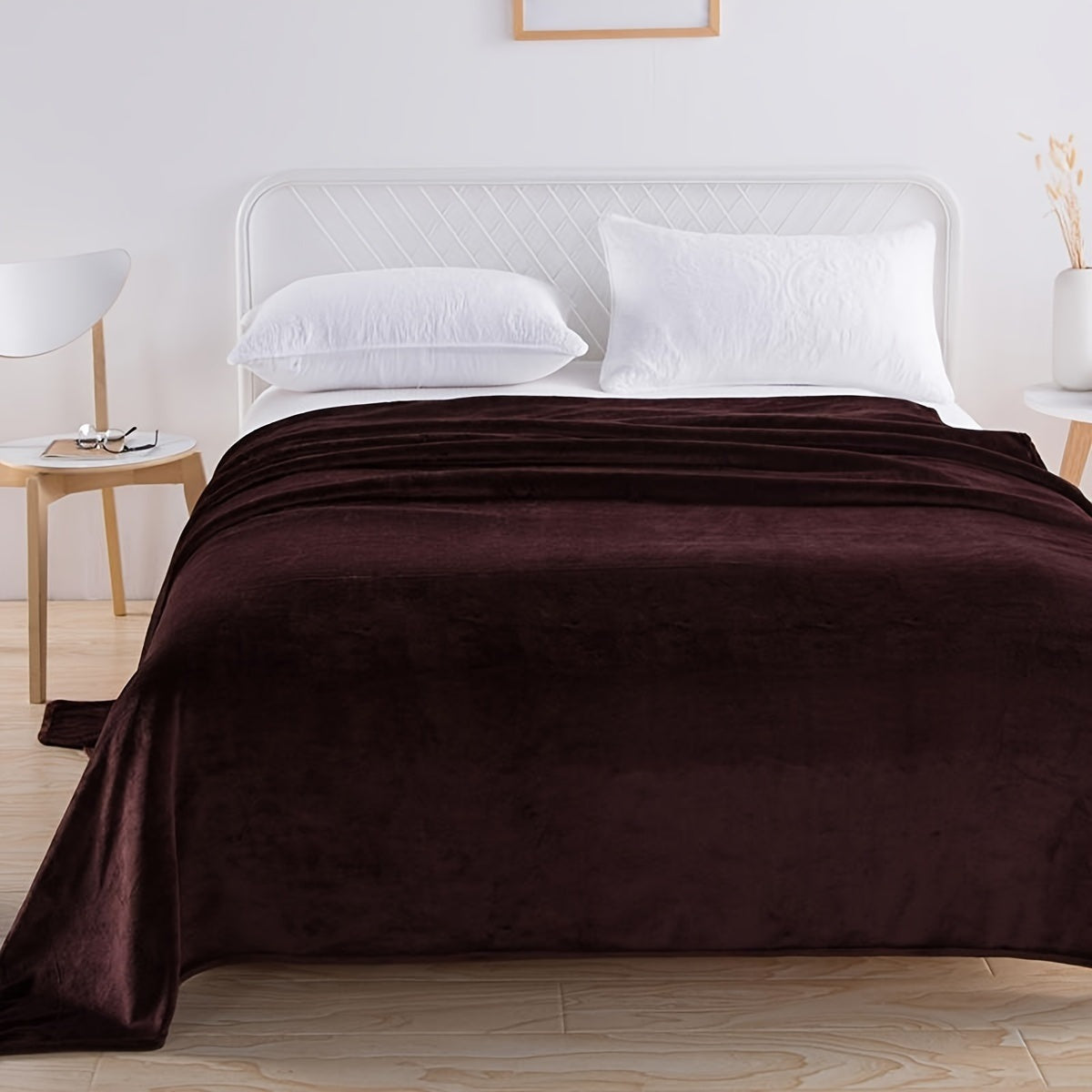 Plain flannel fleece blanket over a bed - dark brown