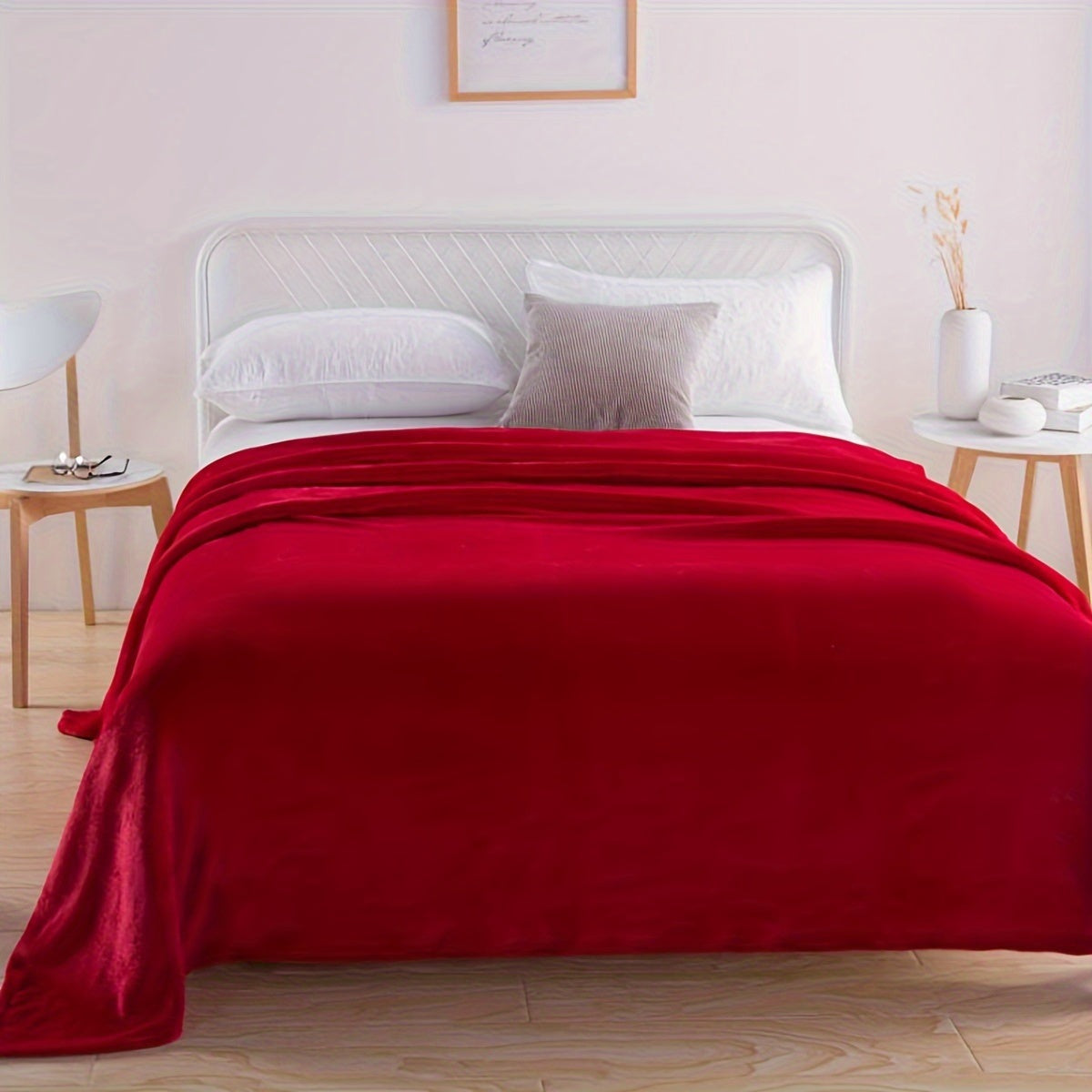 Plain flannel fleece blanket over a bed - red
