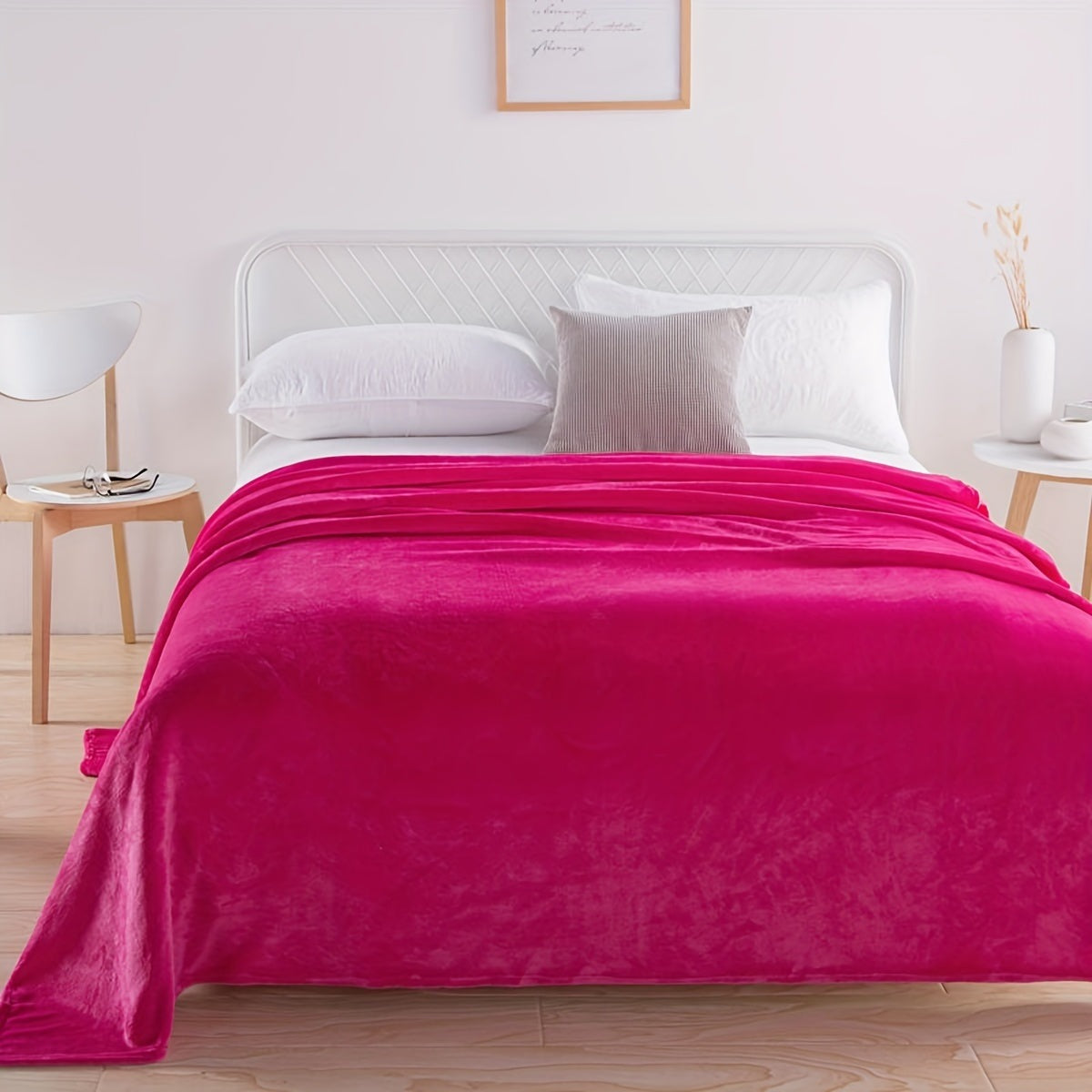 Plain flannel fleece blanket over a bed - fuchsia