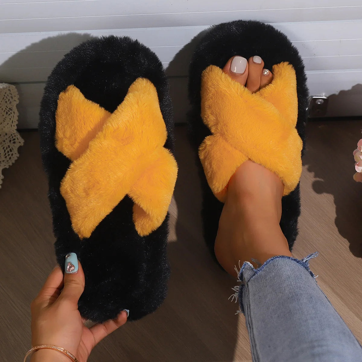 Fluffy slippers with crossed plush straps in a contrast colour on a black plush footbed - orange
