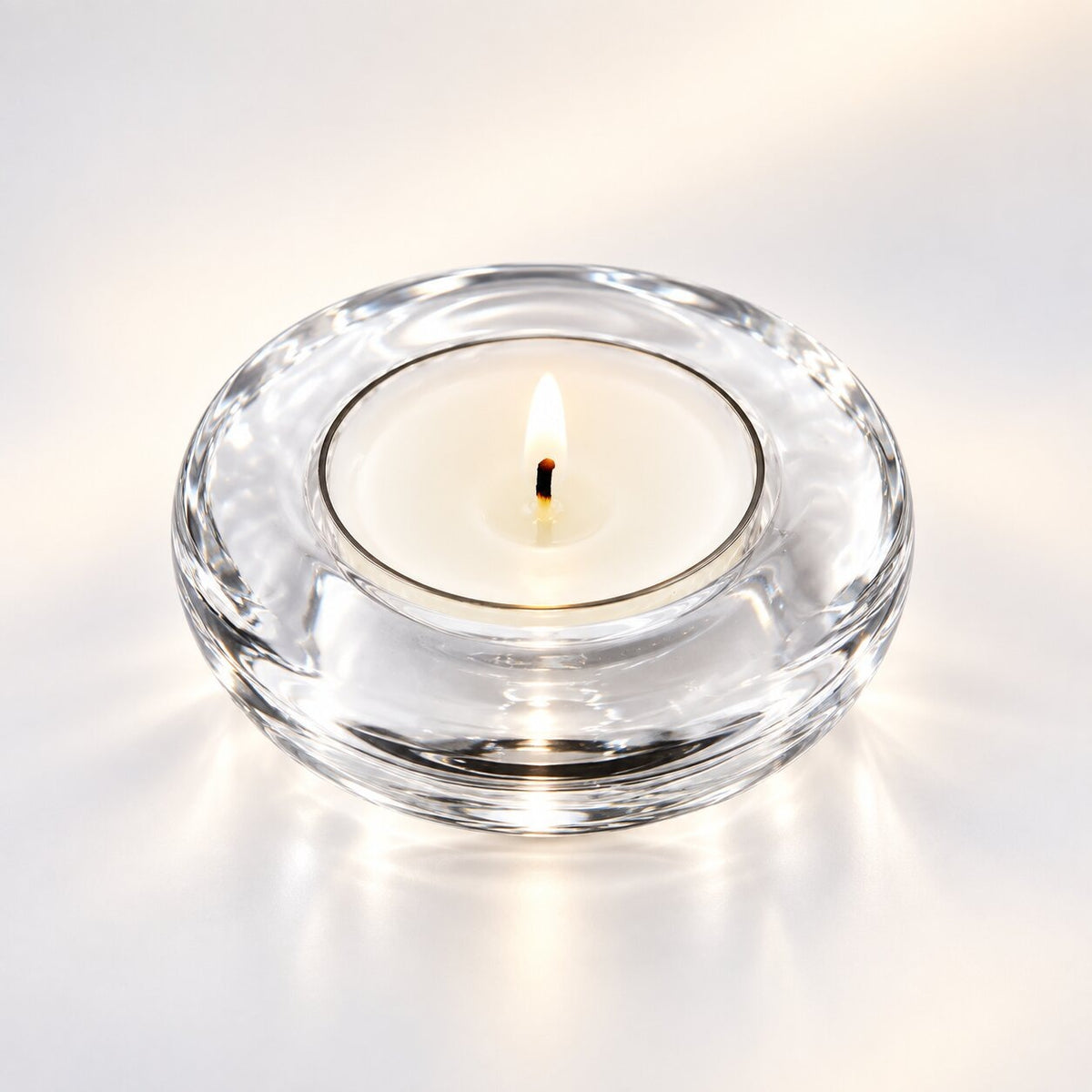 Handmade tea light holder in thick, clear glass - round