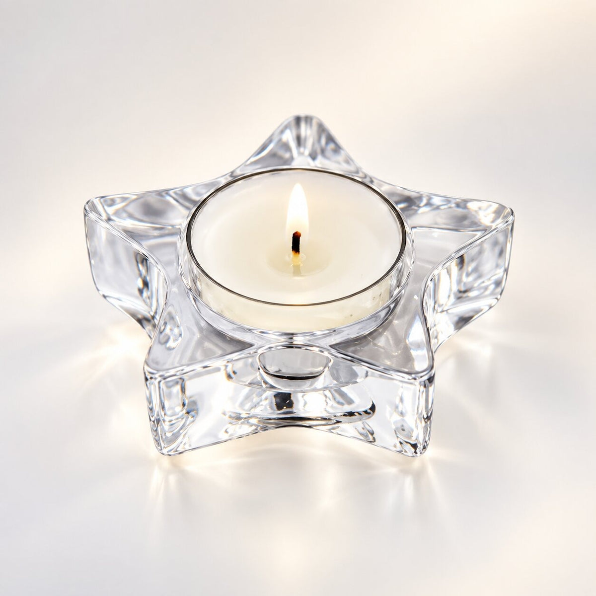 Handmade tea light holder in thick, clear glass - star