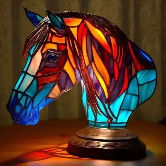 Horse head lamp in a stained glass look with a red and orange mane and a turquoise neck on a round base