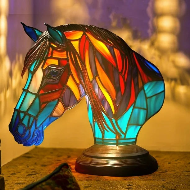 Horse head lamp in a stained glass look with a red and orange mane and a turquoise neck on a round base