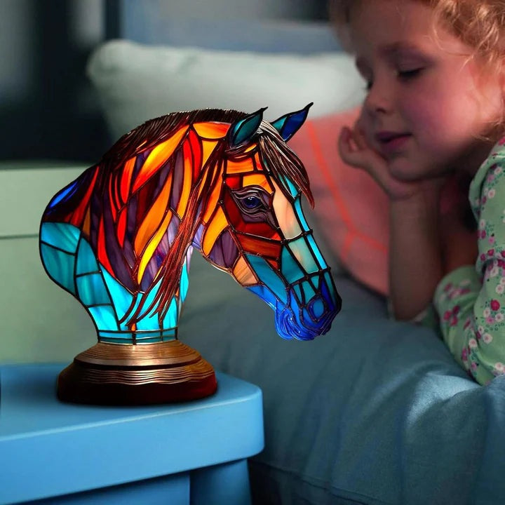 Horse head lamp in a stained glass look with a red and orange mane and a turquoise neck on a round base