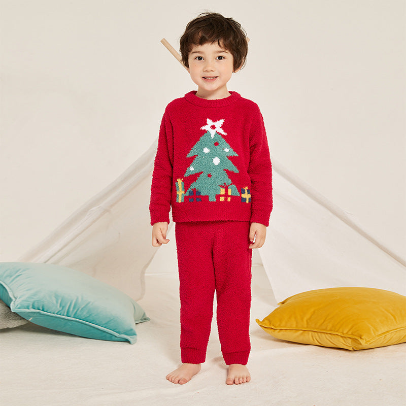 Kids' knitted Christmas pyjamas with a tree on the jumper and plain red bottoms