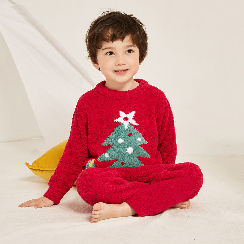Kids' knitted Christmas pyjamas with a tree on the jumper and plain red bottoms