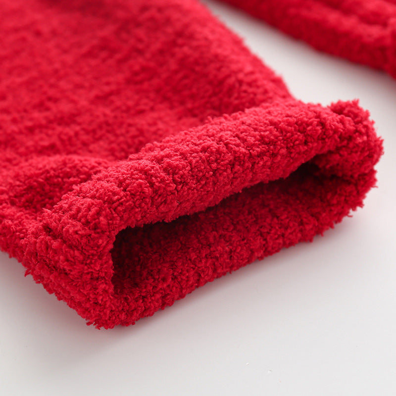 Kids' knitted Christmas pyjamas with a tree on the jumper and plain red bottoms