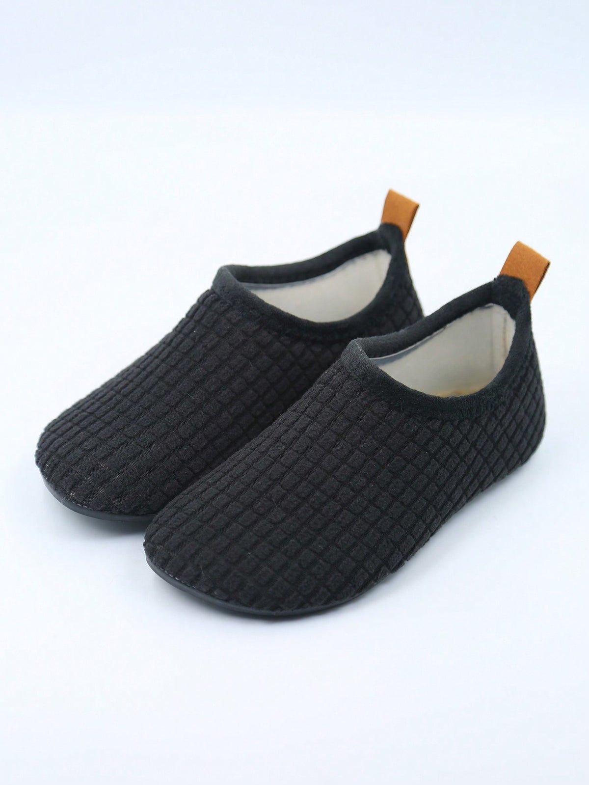 Slipper socks for kids with a soft lined upper, thin rubber sole and a pull-on loop at the heel - black