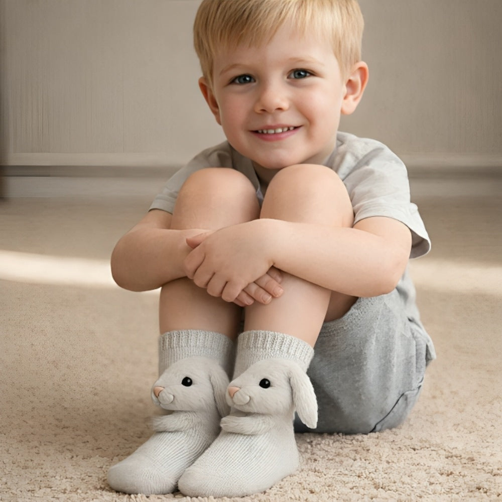 Kids' socks with a knitted 3D animal wrapping its arms around the leg