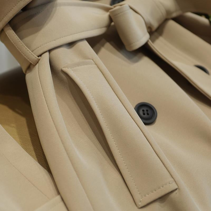 Women's knee-length trench coat with epaulettes and a tie belt