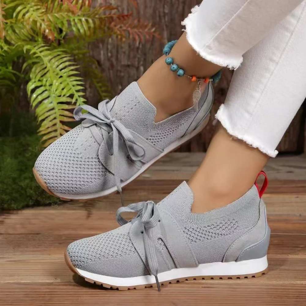 Women's knit slip-on trainers with a tied bow and a red heel tab