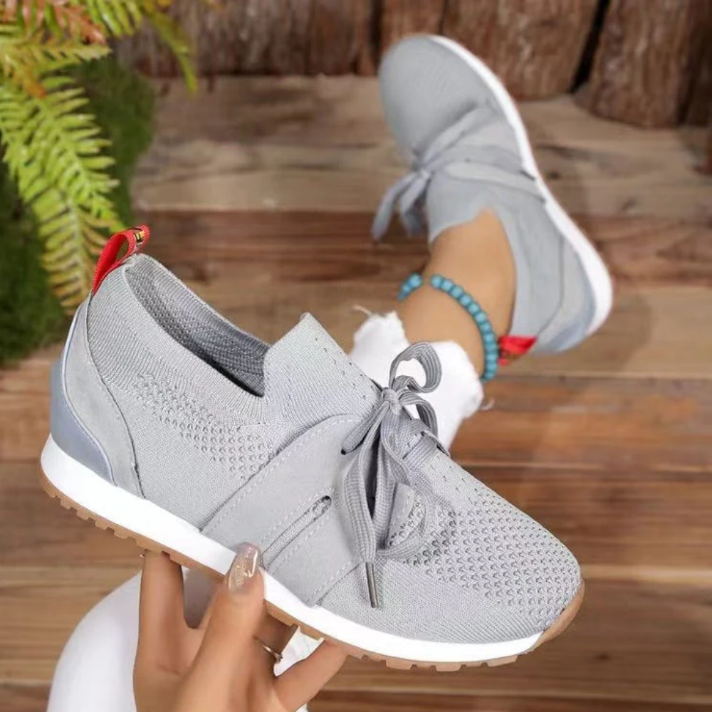 Women's knit slip-on trainers with a tied bow and a red heel tab