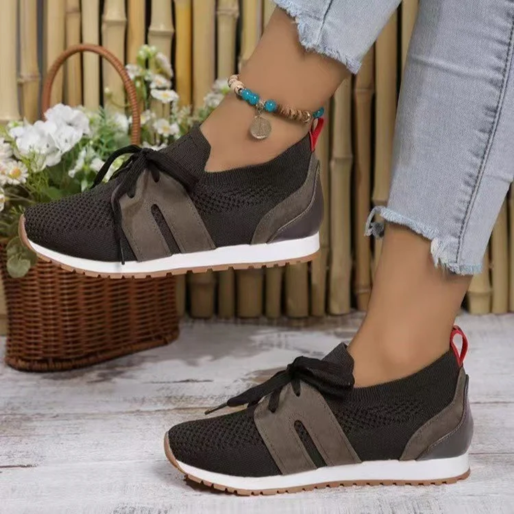 Women's knit slip-on trainers with a tied bow and a red heel tab