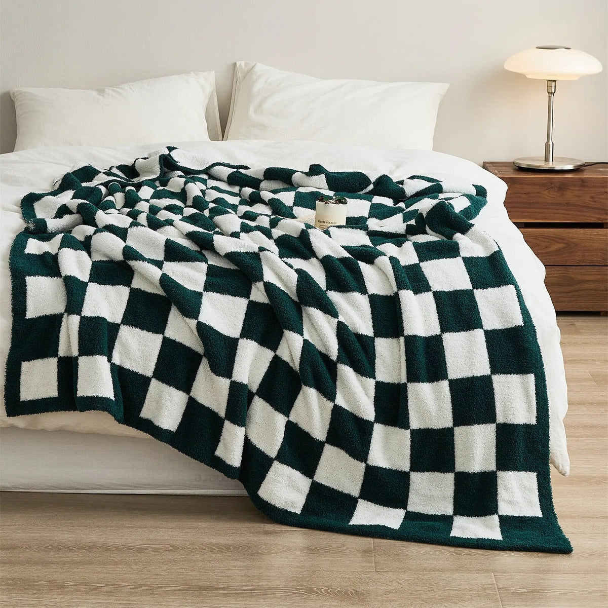 Knitted teddy throw with a checkerboard pattern over an armchair - dark green