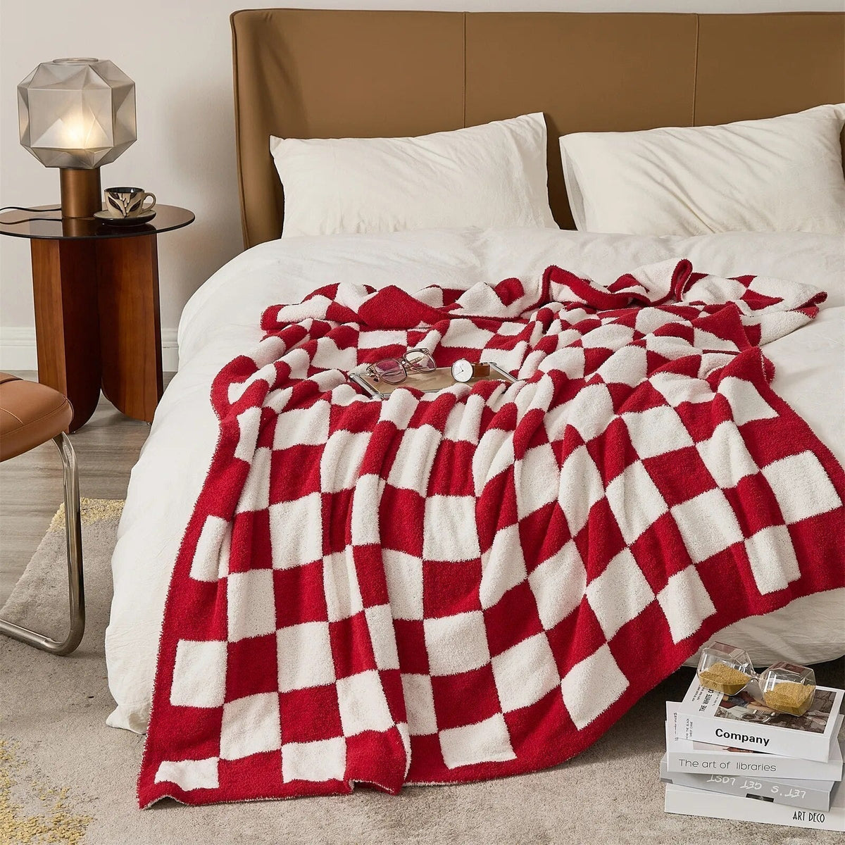 Knitted teddy throw with a checkerboard pattern over an armchair - red