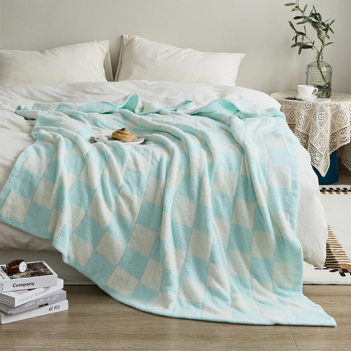 Knitted teddy throw with a checkerboard pattern over an armchair - light blue