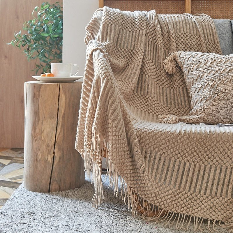 Knitted throw with a Scandinavian pattern and tassels over a chair - view 2
