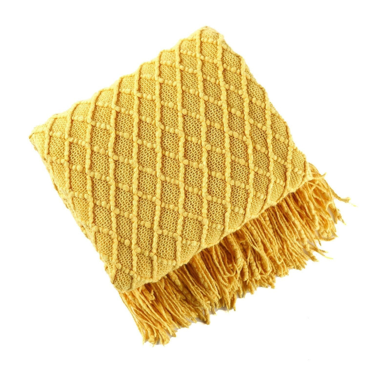 Knitted throw with a Scandinavian pattern and tassels over a chair - golden yellow