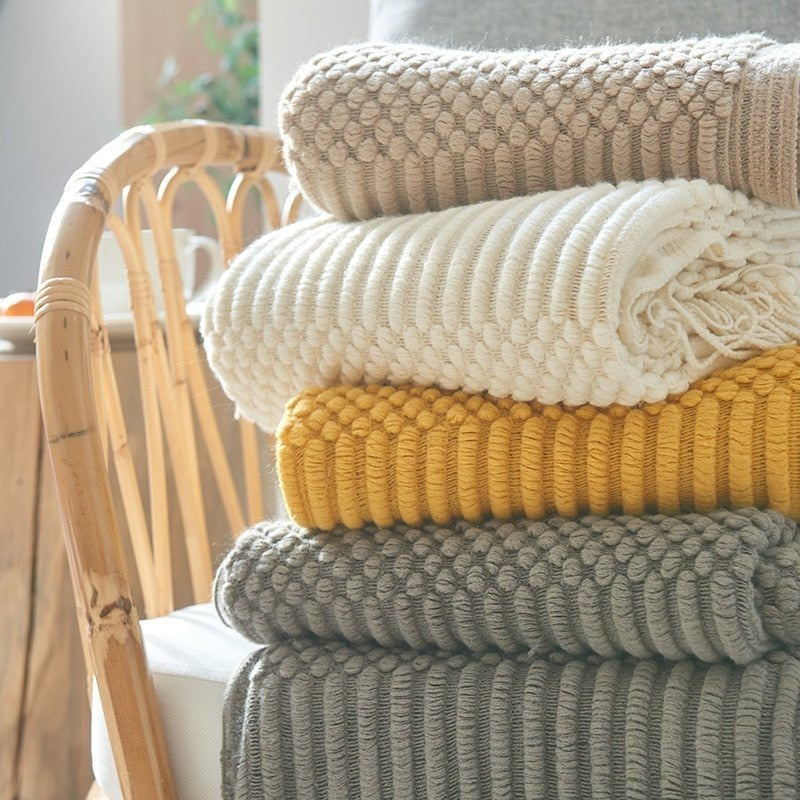 Knitted throw with a Scandinavian pattern and tassels over a chair - view 3