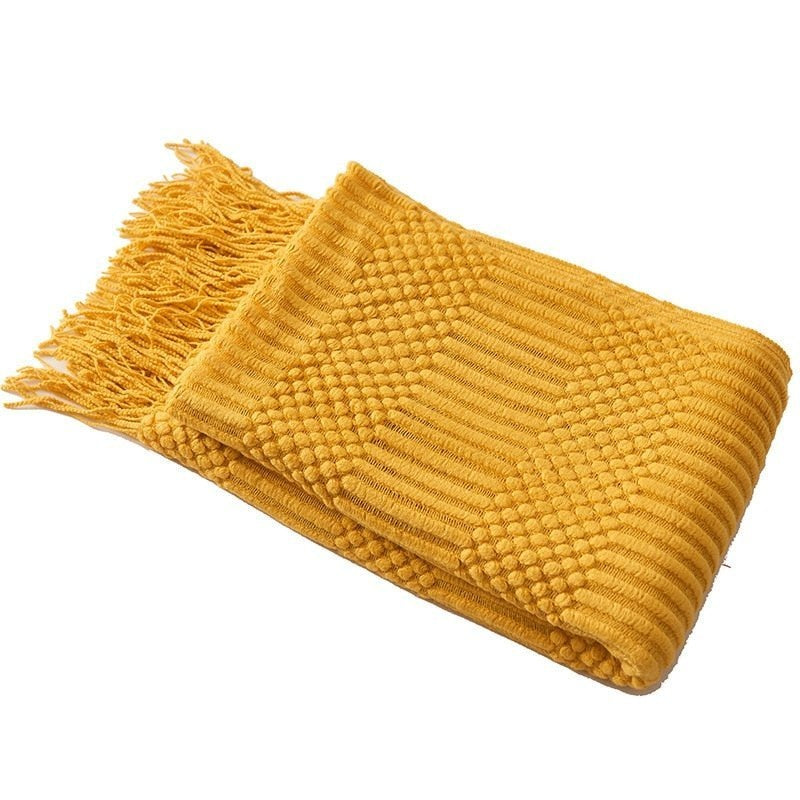 Knitted throw with a Scandinavian pattern and tassels over a chair - view 5