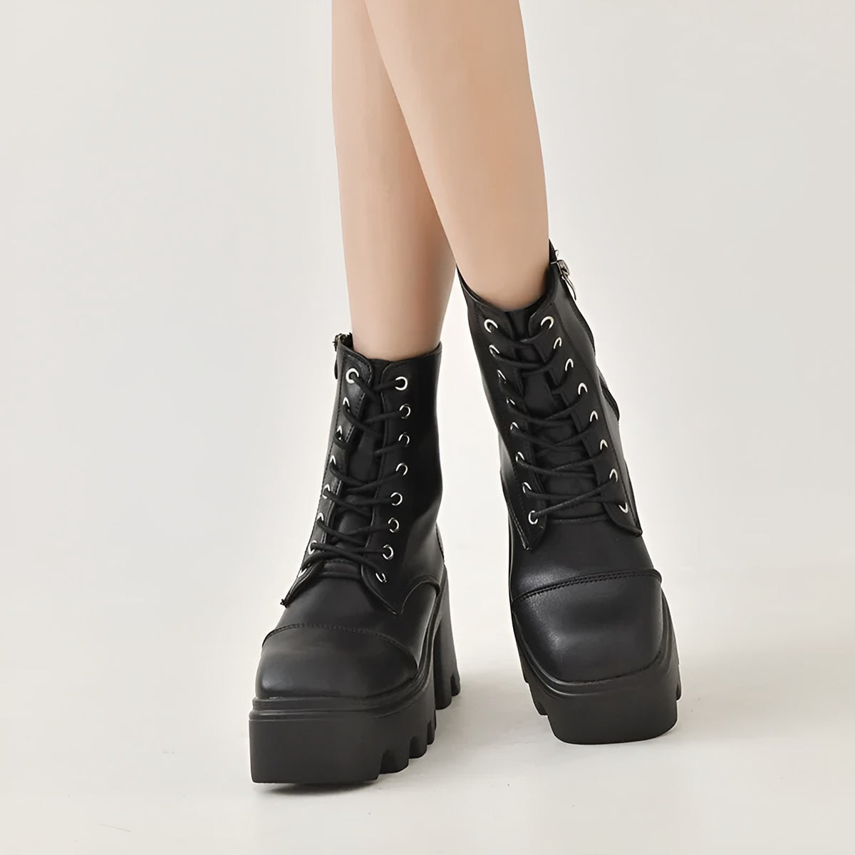 Black lace-up ankle boots for women, front view of the shaft and laces