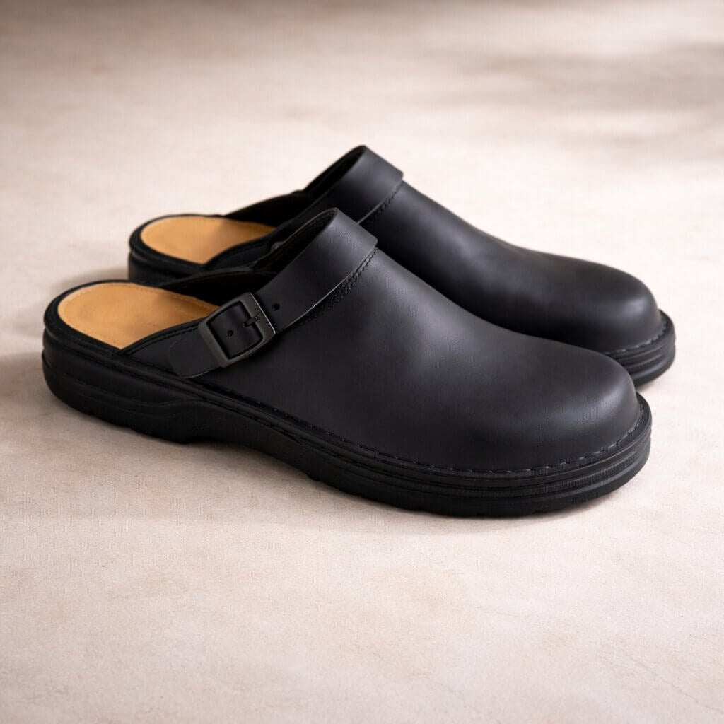 Leather-look slip-on clogs with a buckle strap for women and men - black