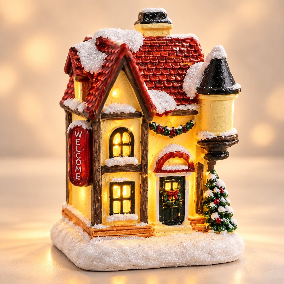 Light-up Christmas house with snow on the roof - welcome house