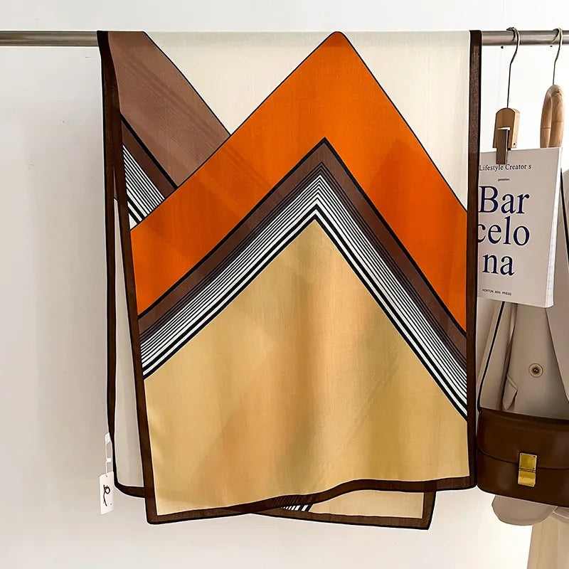 Women's lightweight scarf with a graphic print of blocks and stripes and a narrow contrast border