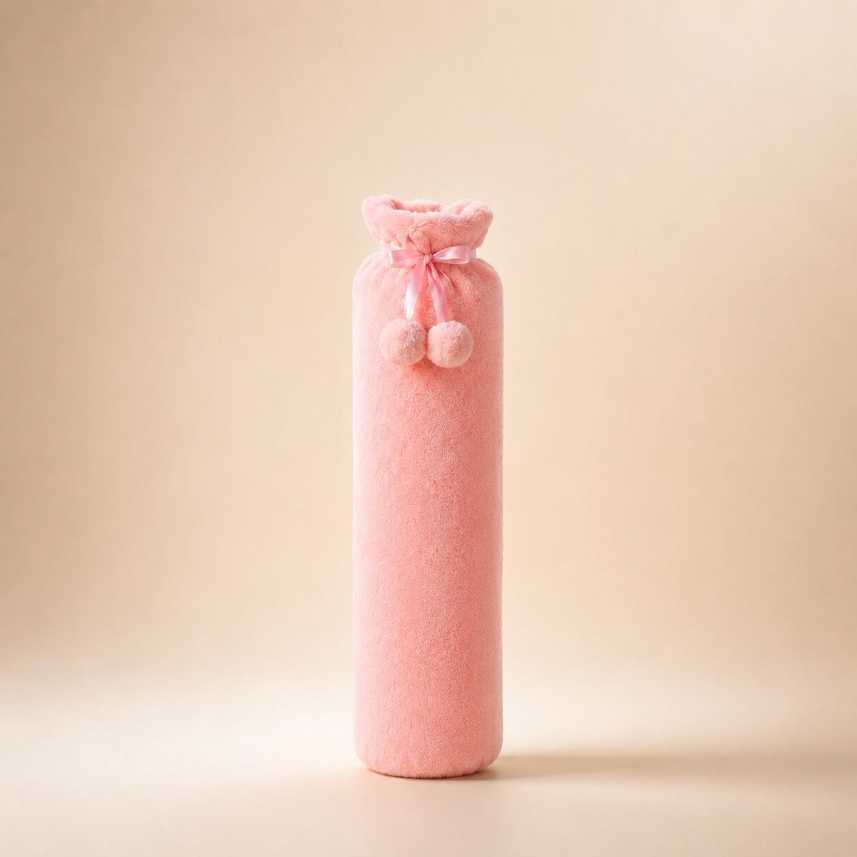 Long hot water bottle with a plush cover and pompoms, small or large - pink, small