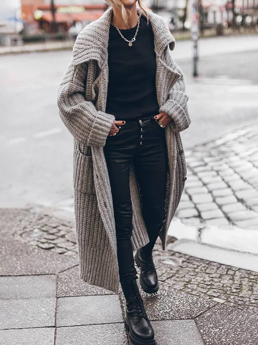 Women's longline chunky knit cardigan with a wide collar and patch pockets
