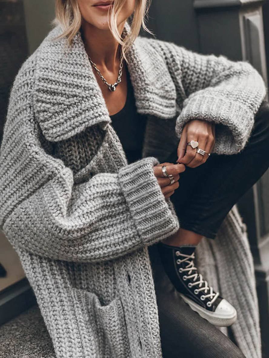 Women's longline chunky knit cardigan with a wide collar and patch pockets
